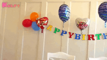 a birthday decoration with balloons and a banner that says happybirth
