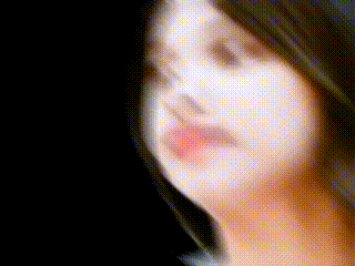 a close up of a woman 's face with a black background