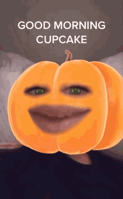 a pumpkin with a face and the words good morning cupcake on it