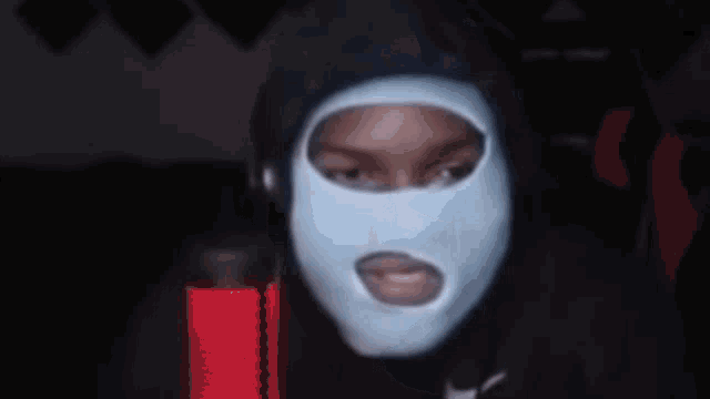 a person wearing a mask with the word who on it