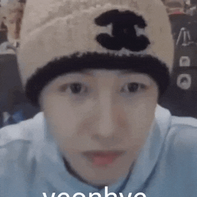 a close up of a person wearing a beanie with the letter j on it .