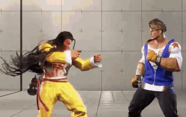 two men are fighting in a video game and one of them is wearing a blue shirt with the letter s on it .