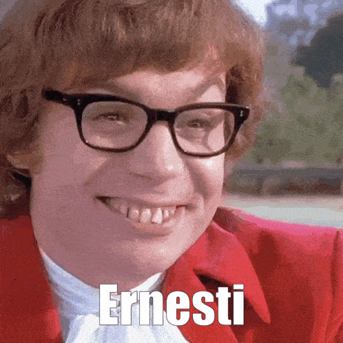 a man wearing glasses and a red jacket with the word ernesti on his face