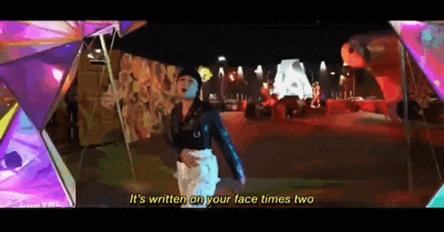 a woman in a black jacket says it 's written on your face times two in a video .