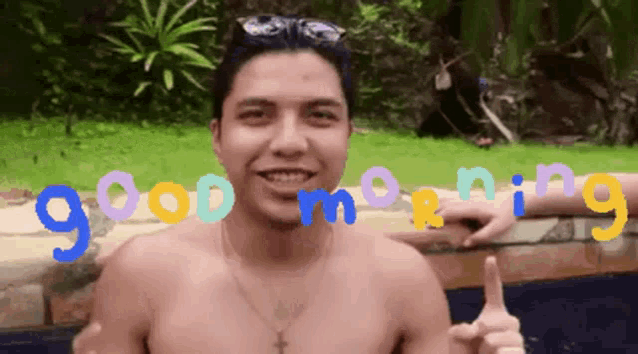 a shirtless man giving a thumbs up with the words good morning written above him