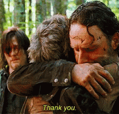 a man hugging another man with the words thank you on the bottom right