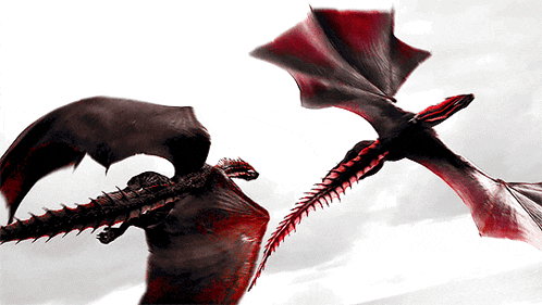 two dragons are flying in the sky with their wings outstretched