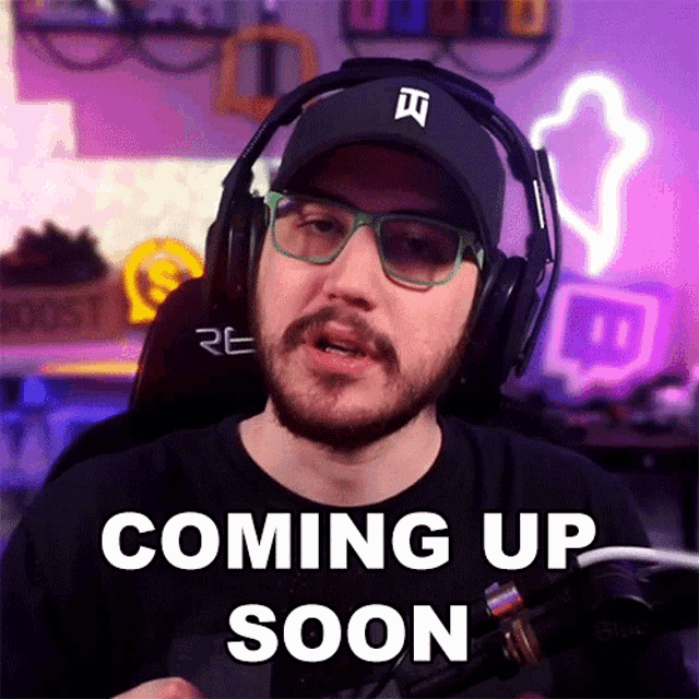 a man is wearing headphones and glasses and says coming up soon