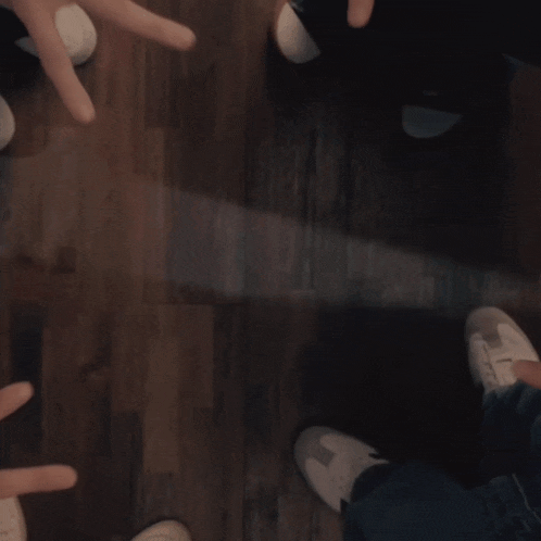 a group of people make a star with their fingers
