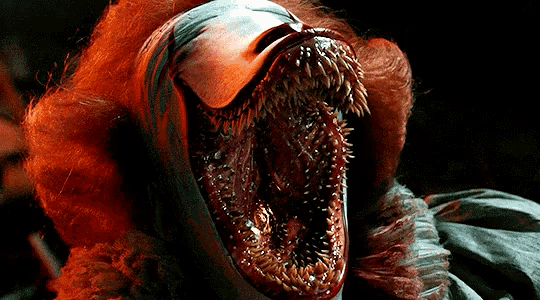 a close up of a clown with a huge mouth