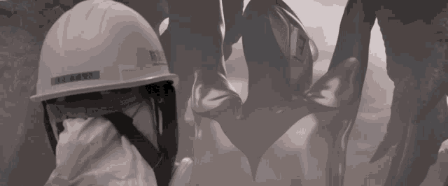 a person wearing a white helmet with a blue sticker that says ' rs ' on it