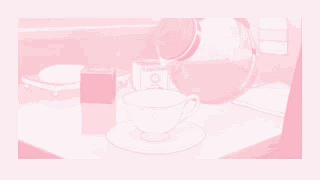 a cup of tea sits on a saucer on a table next to a box of tea