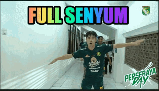 a man in a green shirt is standing in a hallway with the words full senyum written above him