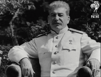 a man in a white uniform is sitting in a chair with a pathe logo in the corner