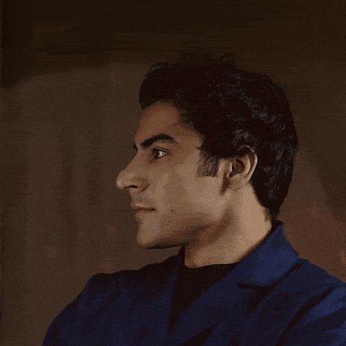 a close up of a man 's face with a black shirt on