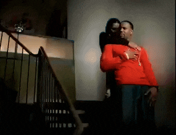 a man in a red shirt is standing next to a woman in a black shirt