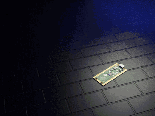 a piece of electronic equipment is laying on a brick floor