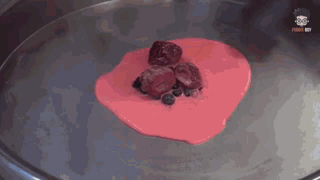 a close up of a heart shaped dessert with berries on top of it