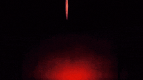 a blurry picture of a person standing in the dark with a white background