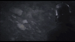 a man wearing a gas mask with a red light on his head