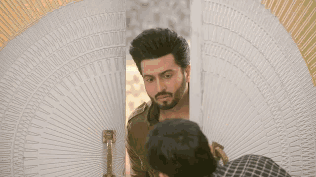 a man is looking at himself in a mirror