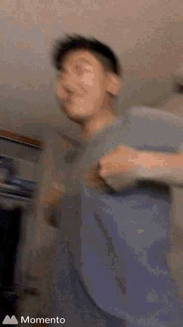 a blurry picture of a man with the word momento on the bottom left