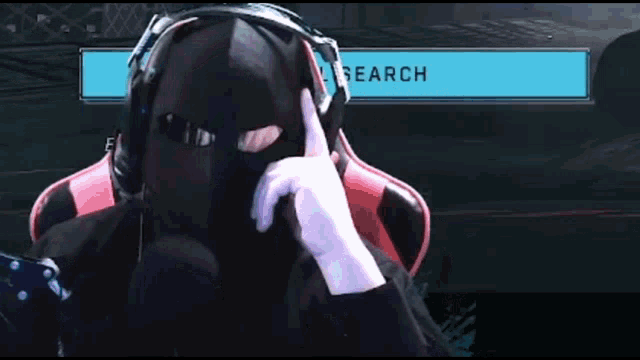 a man wearing headphones and a mask is sitting in front of a search bar and says stop .