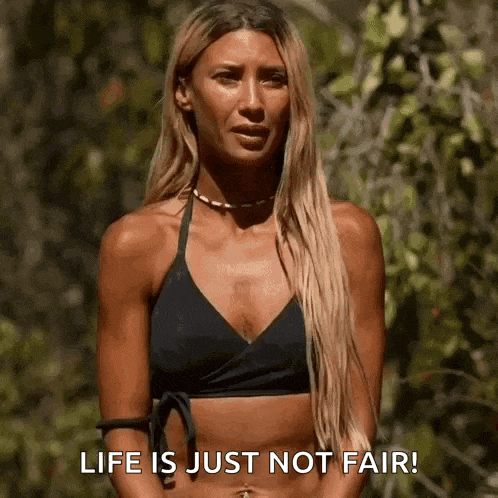 a woman in a black bikini is standing in the woods and says `` life is just not fair '' .