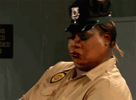 a woman in a police uniform is making a funny face with her mouth open .