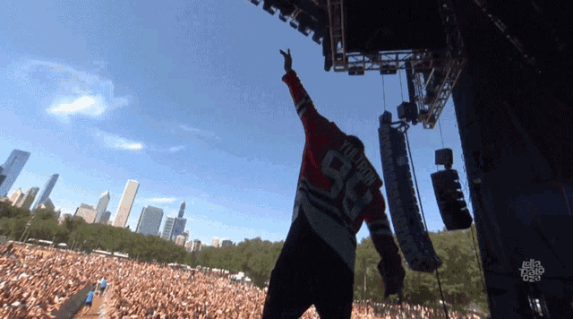 a man wearing a number 98 jersey stands on stage