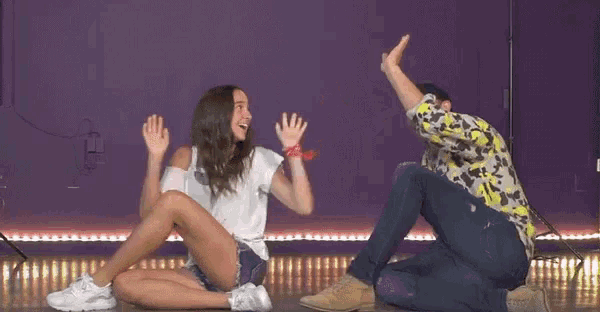 a man and woman giving each other a high five