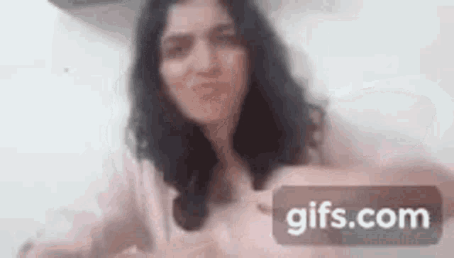 a woman is making a funny face in a blurry photo .
