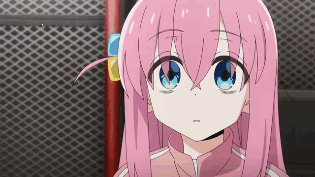 a girl with pink hair and blue eyes is looking at something