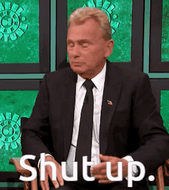 a man in a suit and tie is sitting in a chair with his eyes closed and the words shut up above him