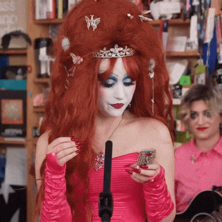 a woman with red hair and a tiara on her head