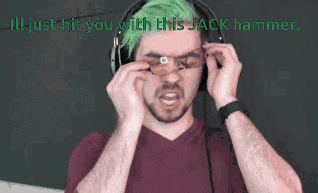 a man with green hair is wearing headphones and glasses and says oh it 's on