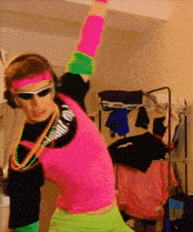 a man in a neon outfit is dancing in front of a big up sign