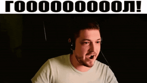 a man wearing headphones and a white shirt is making a funny face in front of a sign that says goooooo