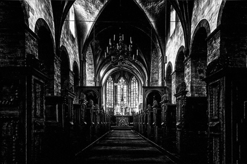 a black and white photo of a church with a cross in the center