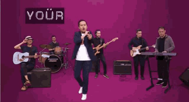 a man stands in front of a band with the words " your ready smile makes it all worthwhile "