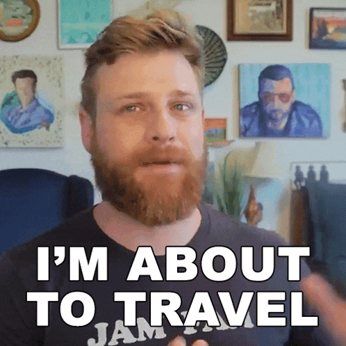 a man with a beard and a black shirt that says i 'm about to travel