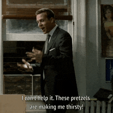 a man in a suit and tie is saying i can 't help it these pretzels are making me thirsty