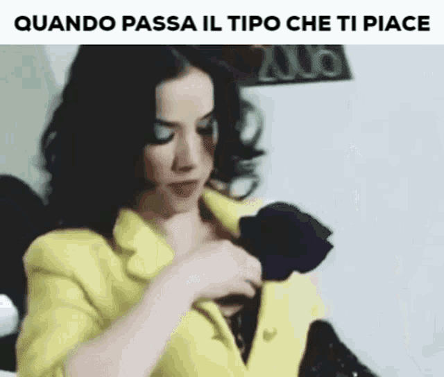 a woman in a yellow jacket is holding a black rose in her pocket .