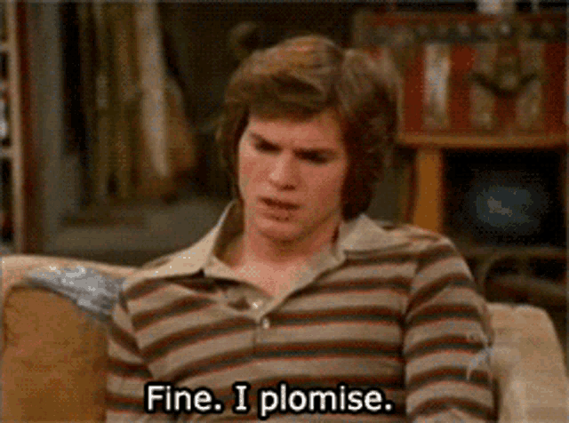 a man in a striped shirt is sitting on a couch and saying fine i promise