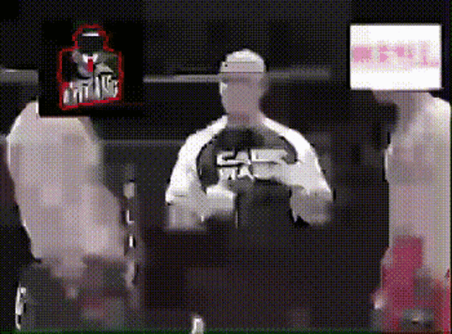 a man is holding a steering wheel and wearing a shirt that says california