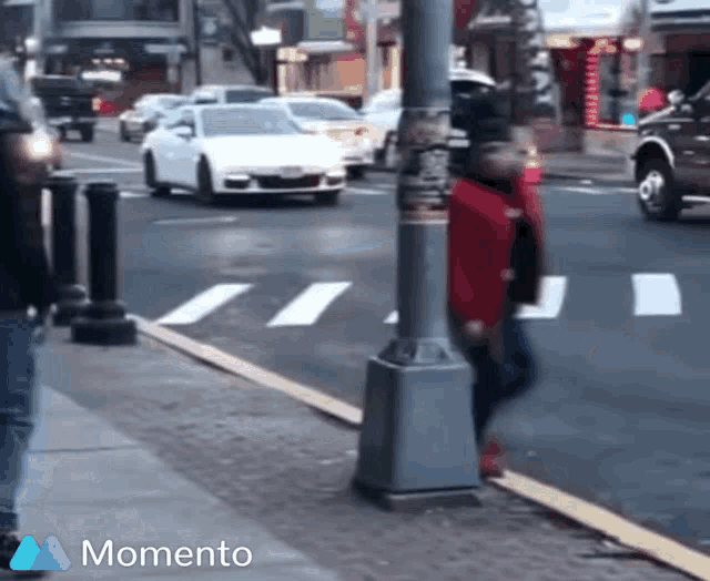 a street scene with a momento logo on the bottom right