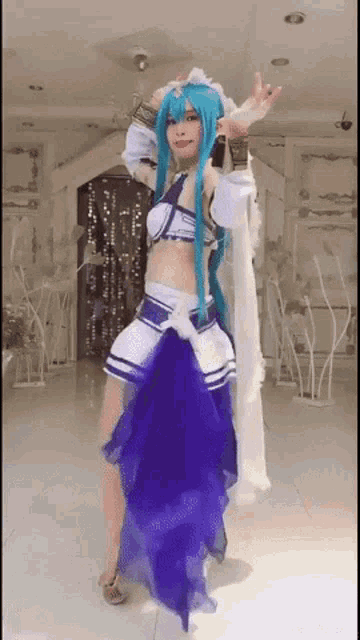 a woman in a blue and white costume is dancing in a room