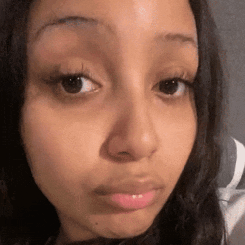 a close up of a woman 's face with her eyes closed .