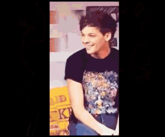 a young man wearing a black t-shirt with a cartoon on it