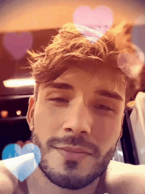 a close up of a man 's face with a beard
